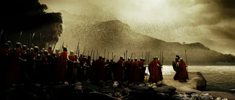 Seen from behind, the Spartans look up at a swarm of arrows in the sky flying towards them.
