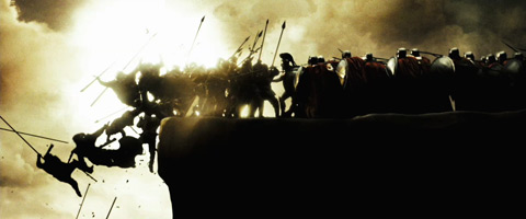 Silhouetted against a sunlit sky, the Spartans push Persians off the edge of a cliff.