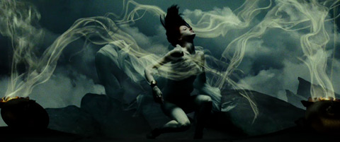 The oracle, a young woman in gossamer robes, does a dance in drugged fumes that looks as though it was shot underwater.