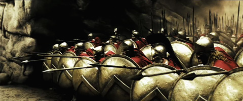 The Spartans align themselves in a tight formation of shields and spears pointed forward.