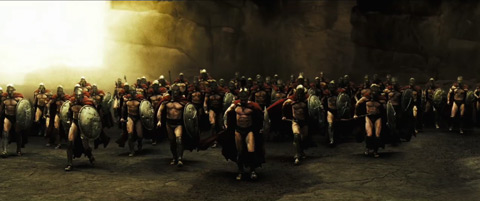 The Spartans run towards the camera from the cliff pass.