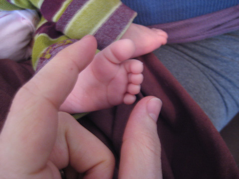 My fingers showing the size of her foot, which is probably and inch and a half across.
