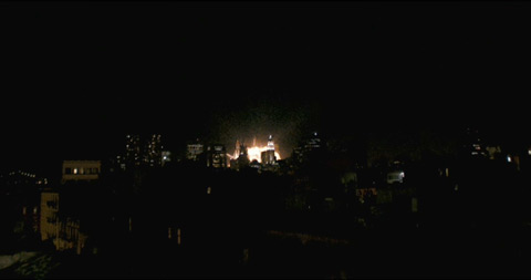 An explosion in the New York skyline, seen from a distance at night.