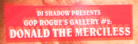 A close-up of the sign on his forhead, which reads: DJ Shadow presents GOP Rogue's Gallery #2: Donald the Merciless.