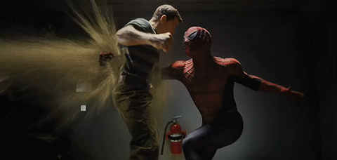 Spider-Man punches Sandman in the stomach, sending a burst of sand out his back.