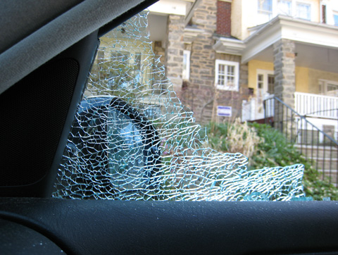 Our house, as seen from inside my car, partly obscured by the shattered remains of my car window.