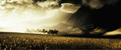 Horsemen ride among fields and mountains.
