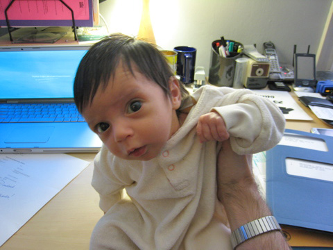 Blackbird, sitting up and raising her left arm as she slouches.