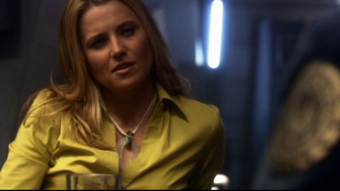 Lucy Lawless playing a reporter speaking with one of the crew.