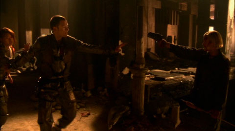 Kara points her sidearm at Sharon and Helo blocks her shot.