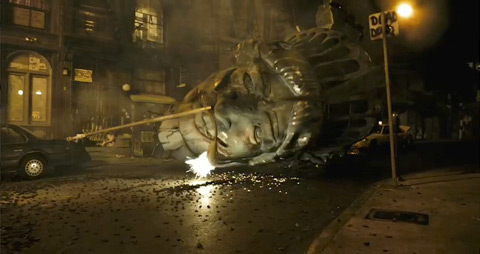 The head of the Statue of Liberty laying on the street, lit by a fallen streetlight's sparking. The head has large gashes in the metal.