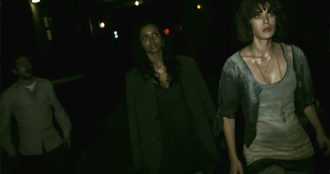 Rob, Marlene and Lily, lit by Hud’s camera light, stand still to listen in a darkened tunnel.