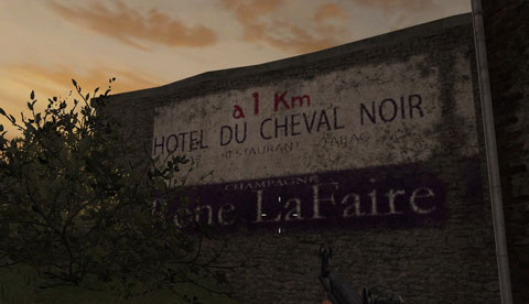 A French painted sign on a wall at sunset with inaccurate fonts.