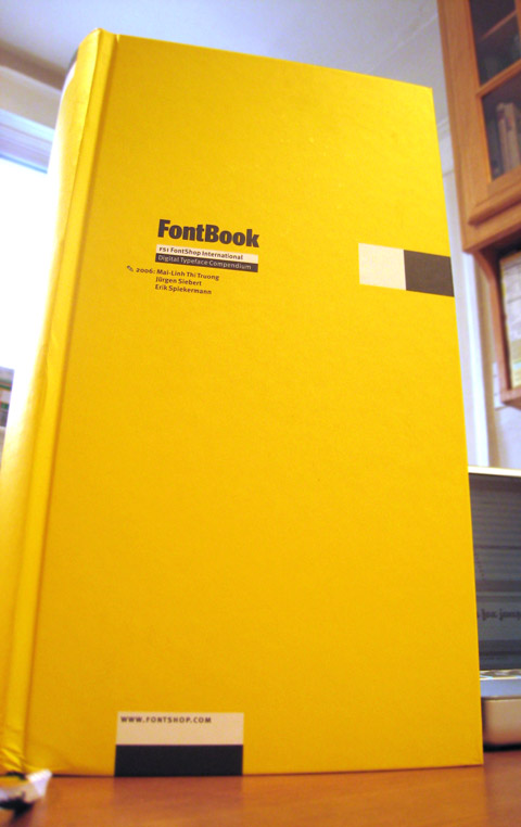 FontBook, seen from a worm's eye view, towering over a laptop behind it.