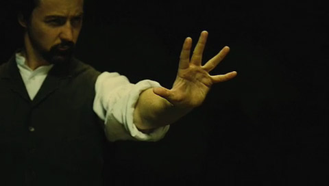 With his sleeves rolled up, Eisenheim concentrates with a furrowed brow and outstretched hand.