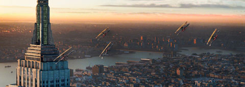 The New York City vista, looking at Kong on the upper levels of the Empire State Building as biplanes come back for another strafing run.