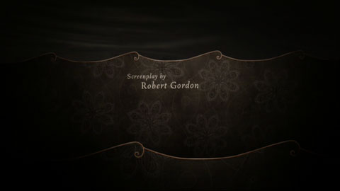 Stylized waves, like pieces of paper, with ornate patterns on them, in front of a stormy sky, behind small credits