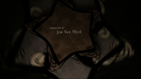A stylized pinwheel spins around with the credits over top of the center axis