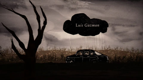 The car, seen from the side, drives down a spooky, overcast country road, underneath a small black rain cloud that hovers over them persistently. Inside the cloud are the credits.