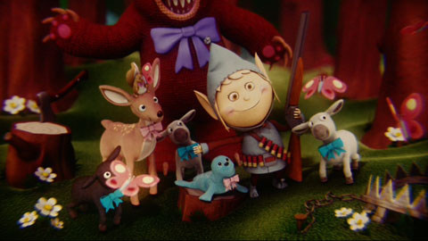 Bright, happy claymation elves and forest creatures gather together singing. The elf has a shotgun and ammo belt on.