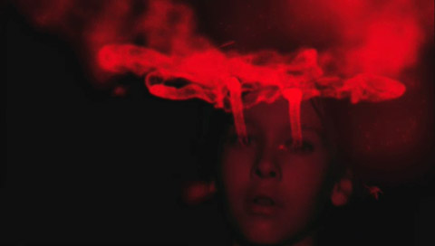 Yegor, the young boy, falls backward in the dark crimson Gloom, his eyes leaving a cloudy red trail.