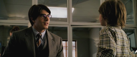 Clark Kent at the office, talking with Louis Lane's son.