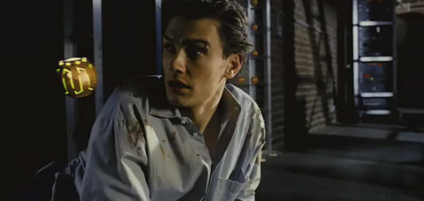 Harry, who's been beaten, looks over his shoulder at an explosive passing by his face.