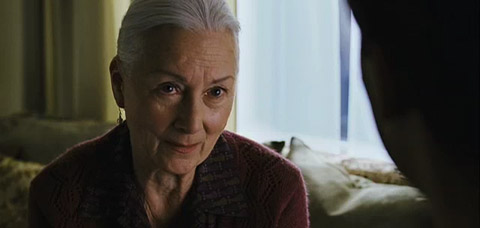 Aunt Mae speaks earnestly to Peter in her home.