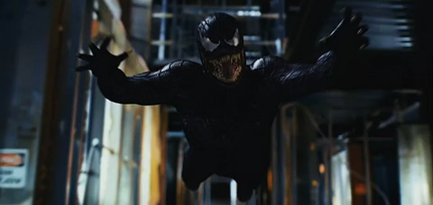 Venom leaps towards the viewer, arms out, fangs bared.