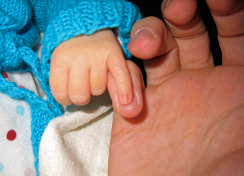 My daughter's pinky laid over my own.