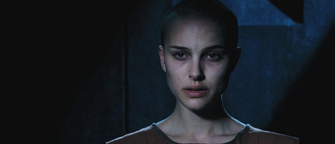 Evey looking very gaunt and starkly lit with a shaved head.