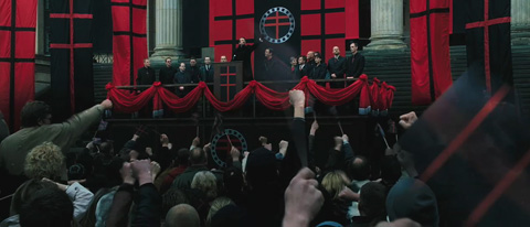 Sutler speaks at a Norsefire rally, very reminiscent of real-world fascist rallies, with a cheering crowd in attendance.