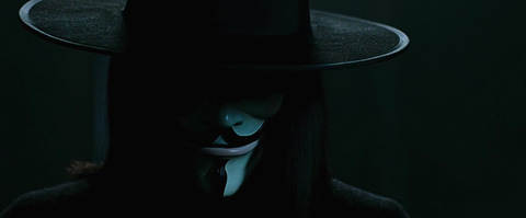 V with his hat, a shadow across most of his face.